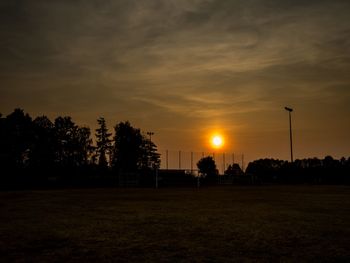 Silhouette trees against sky during sunset