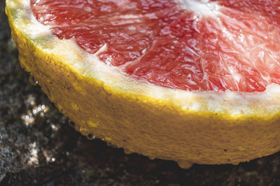 Close-up of wet and refreshing grapefruit on table