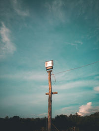 Low angle view of telephone pole against sky at dusk