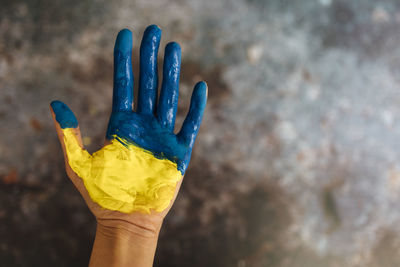 Female hands painted in the colors of the flag of ukraine. no war and peace concept.