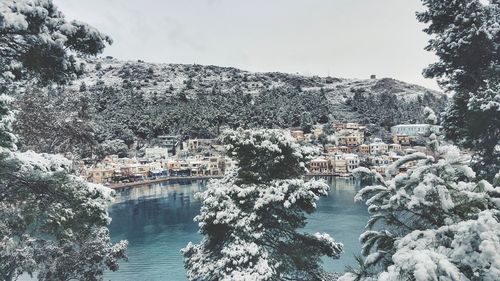 Scenic view of town by the sea in winter