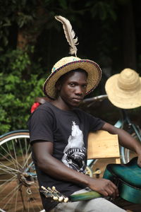 Portrait of young man wearing hat with guitar