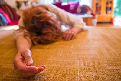 Unconscious woman lying on floor at home