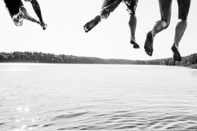 Friends diving into water 