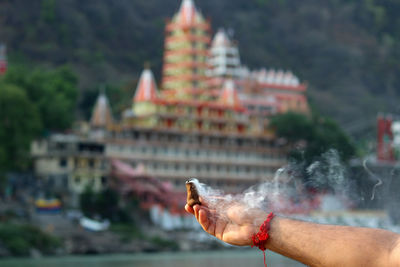  indian man doing puja for ganga river in rishikesh