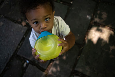 Toddler boy stays hydrated on summer day 