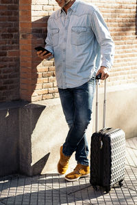 Low section of man standing on tiled floor