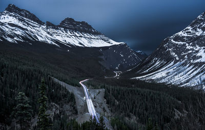 Scenic view of snowcapped mountains against sky at night