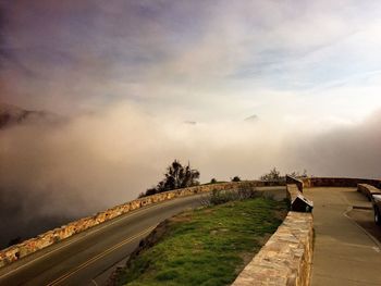 Empty mountain road against sky