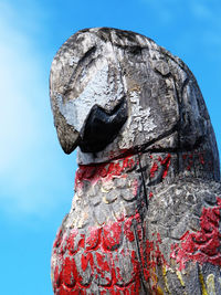 Low angle view of statue against blue sky