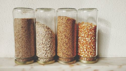 Close-up of food in glass jars on table