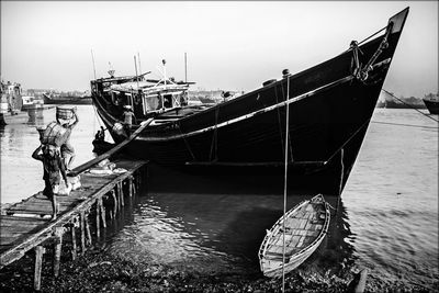 Ship moored on sea against sky