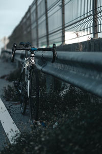 Bicycle parked on railing in city