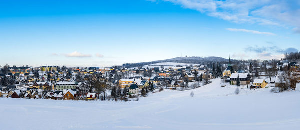 Panoramic view of townscape against sky during winter