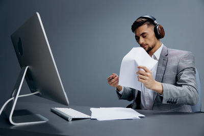 Businessman with headphones holding paper