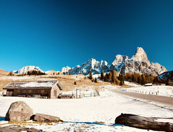 Scenic view of snowcapped mountains against blue sky