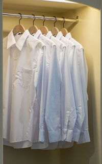 White clothes hanging on rack