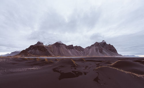 Panoramic view of sea and mountains against sky