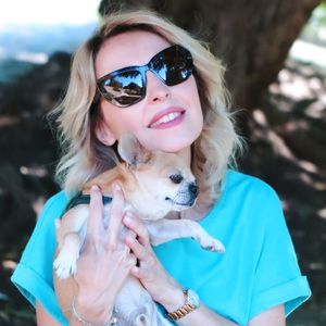 Portrait of woman holding dog