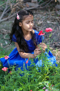 Close-up of woman holding flower petals on land