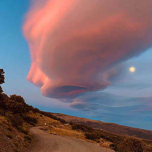 Scenic view of volcanic mountain against sky during sunset