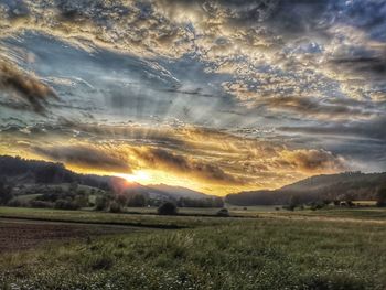 Scenic view of field against sky during sunset