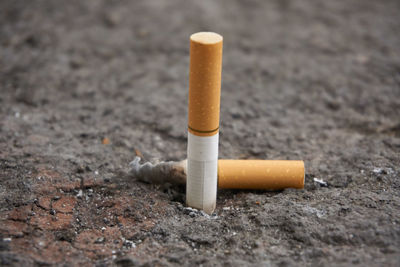 Close-up of cigarettes on ground