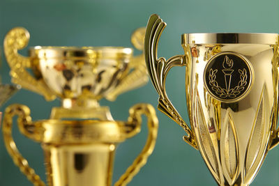 Close-up of trophies against blackboard