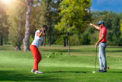 Golf vacation for couples, playing golf in a beautiful sunny weather