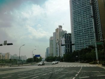 City street and buildings against sky