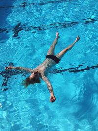 High angle view of woman swimming in pool