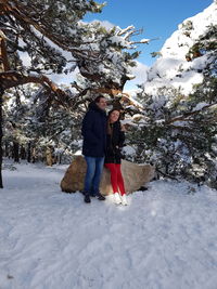 Full length of woman walking on snow covered tree