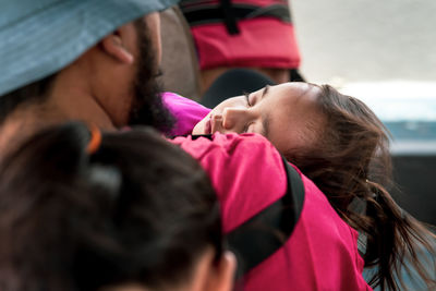 Toddler sleeping on a moving boat wearing life jackets