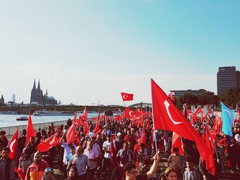 Group of people holding up flags