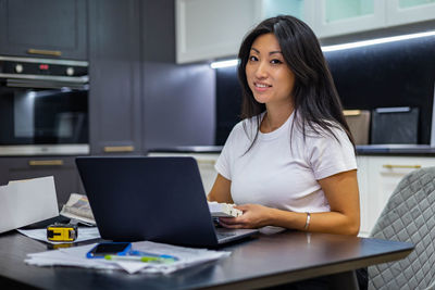 Young woman using laptop at office