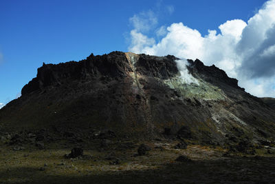 Low angle view of rocky mountain against sky