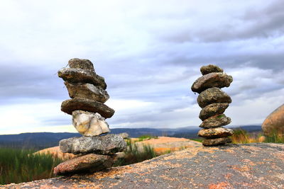 Stack of rocks on land against sky