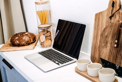 Coffee and laptop on table