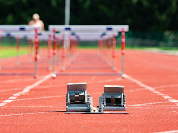 Obstacle course training. athletics starting blocks and red running tracks in a stadion
