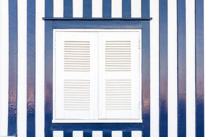 Detail of typical facade of aveiro, white window over blue stripped wall.costa nova, aveiro,portugal