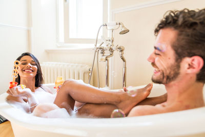 Portrait of shirtless man in bathroom