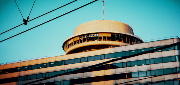 Low angle view of modern building against clear blue sky