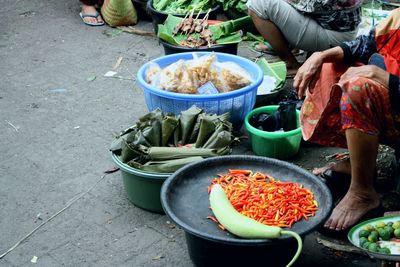 Low section of people selling food in market stall