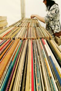 Side view of woman choosing records for sale in store