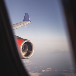 Close-up of airplane wing against sky