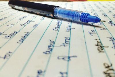 Close-up of hand writing on paper