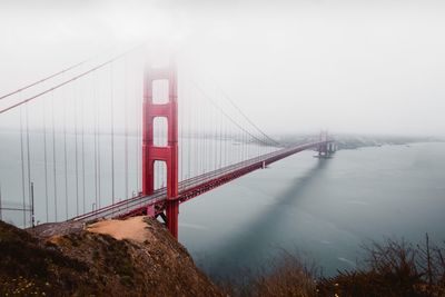 View of suspension bridge in foggy weather