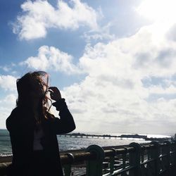 Young woman photographing through smart phone
