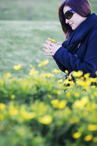 Close-up of woman holding flower