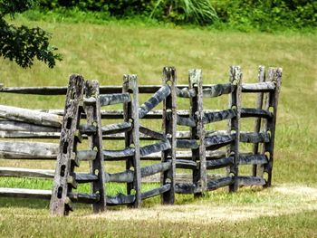 Empty wooden post on grassy field